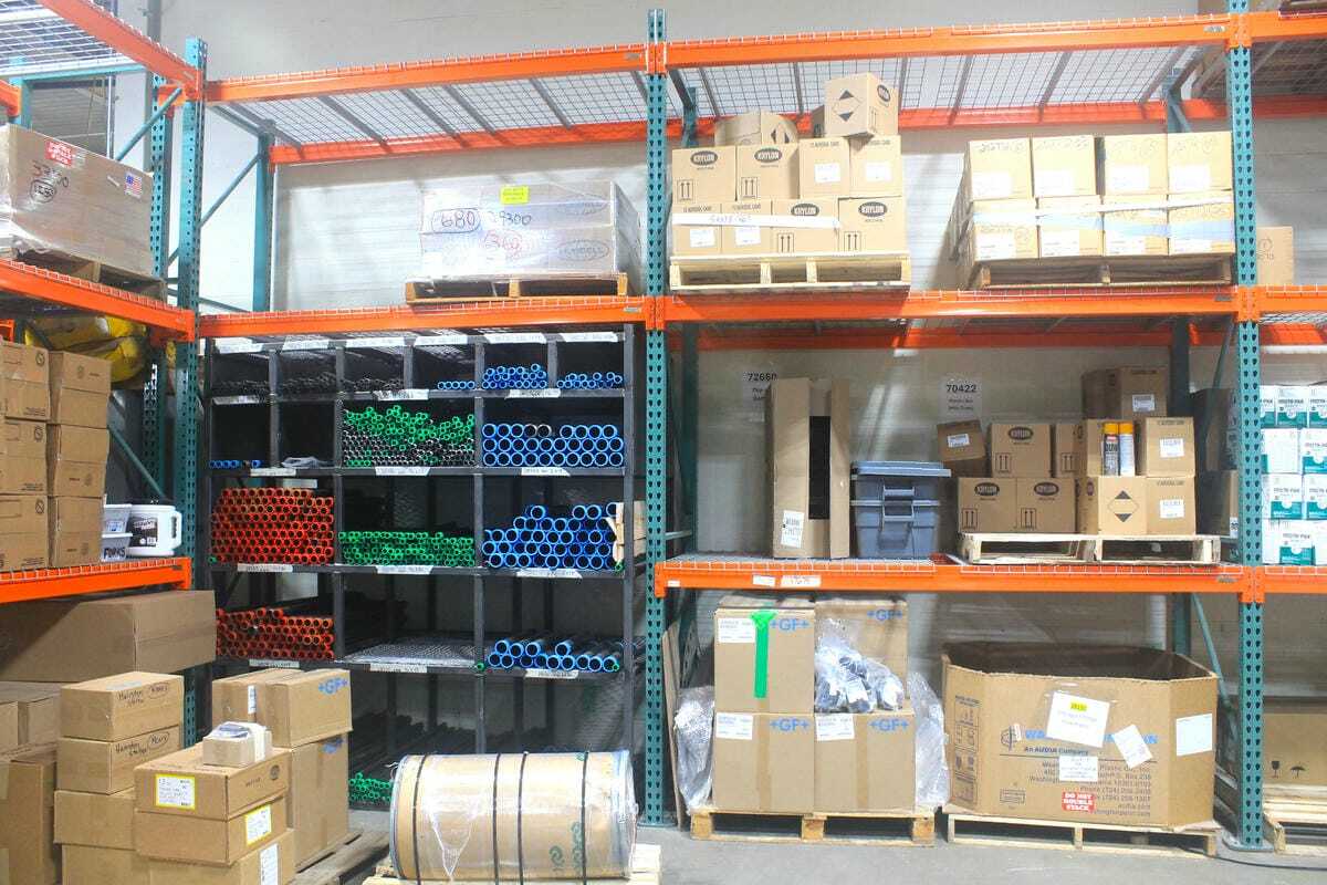 More pallet racking straddling custom racking for long metal pipe storage