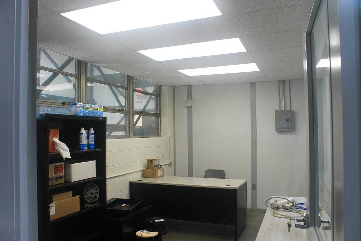 Interior of modular office showing work desk and lighting
