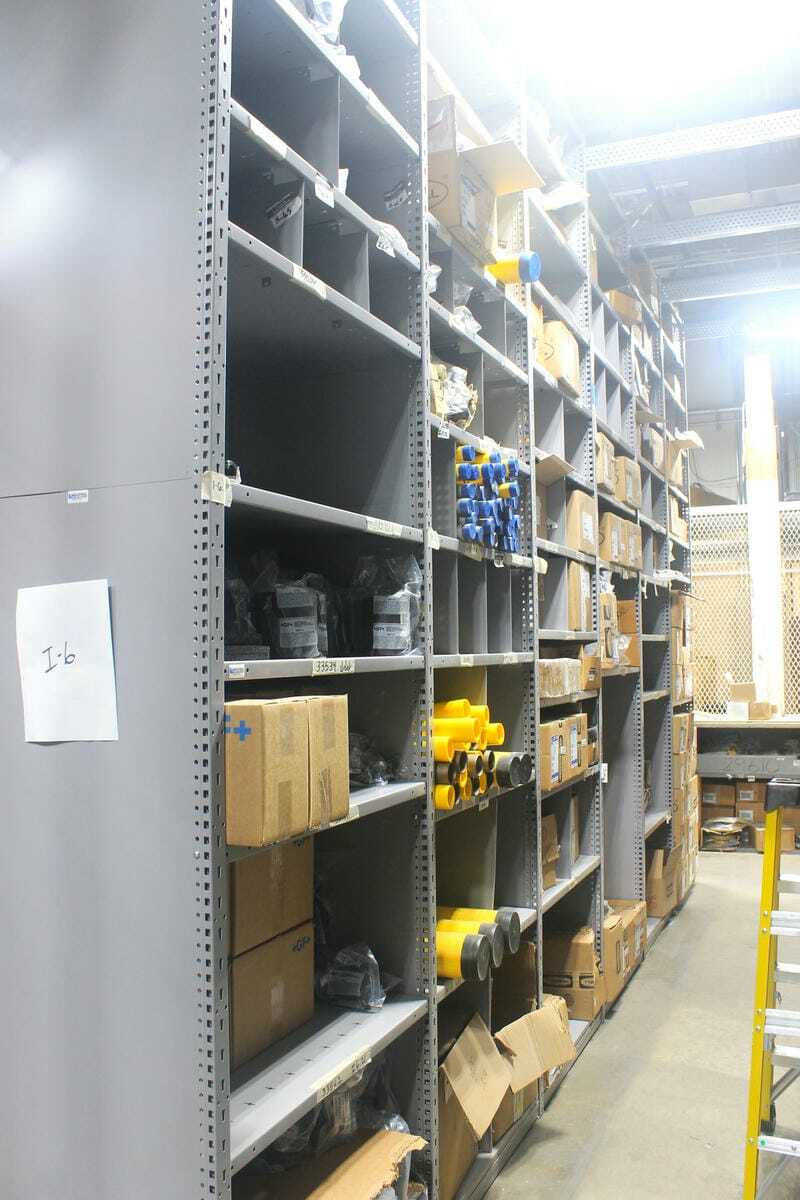 Rousseau spider shelving system with labeled inventory bins